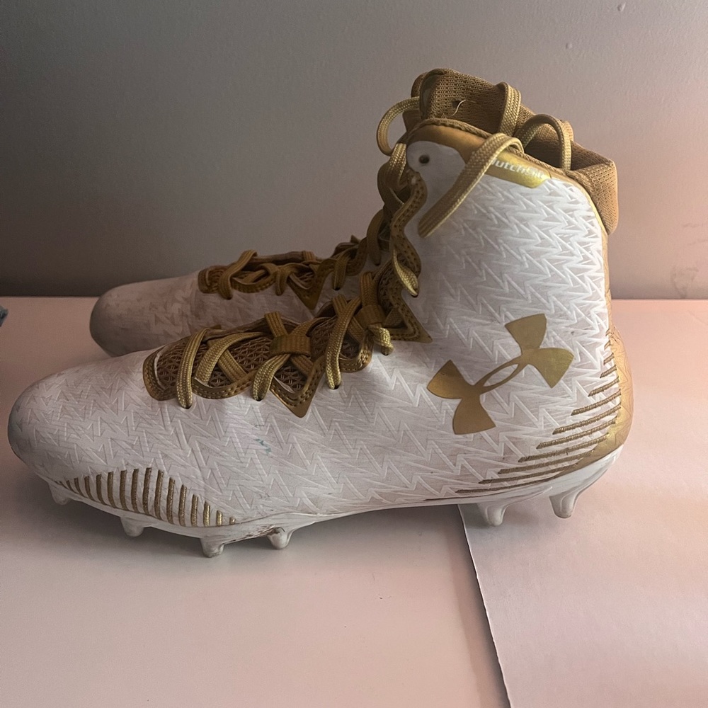 Under Armour white and gold cleats size women’s 8.5.